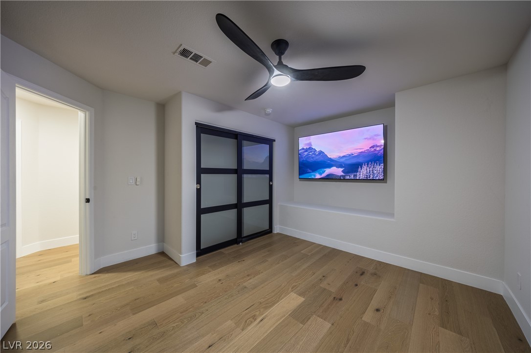 8800 Lusso Las Vegas, NV 89134 - Photo 75 of 85 Unfurnished bedroom featuring light wood finished floors, ceiling fan, and a closet