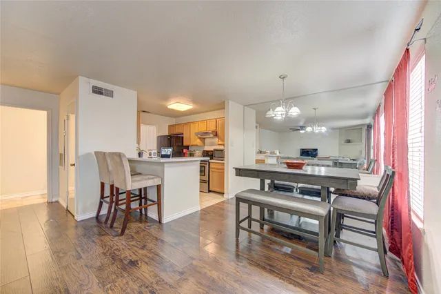 a view of kitchen with cabinets and wooden floor