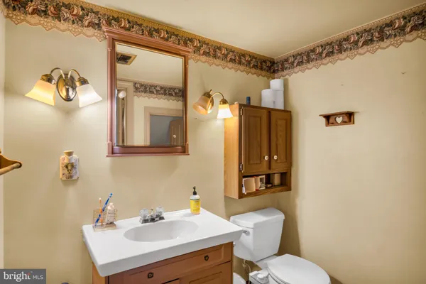 a bathroom with a sink mirror toilet and shower