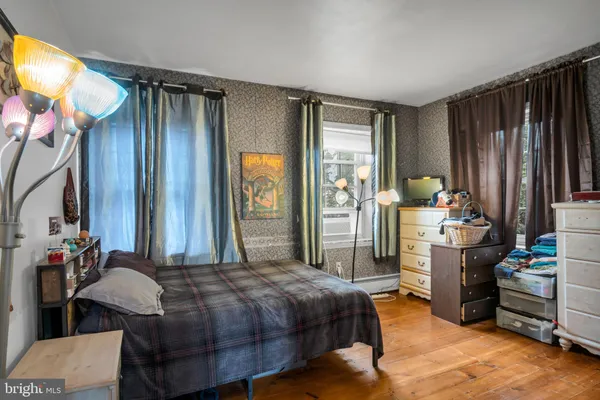 a bed room with a bed and a television