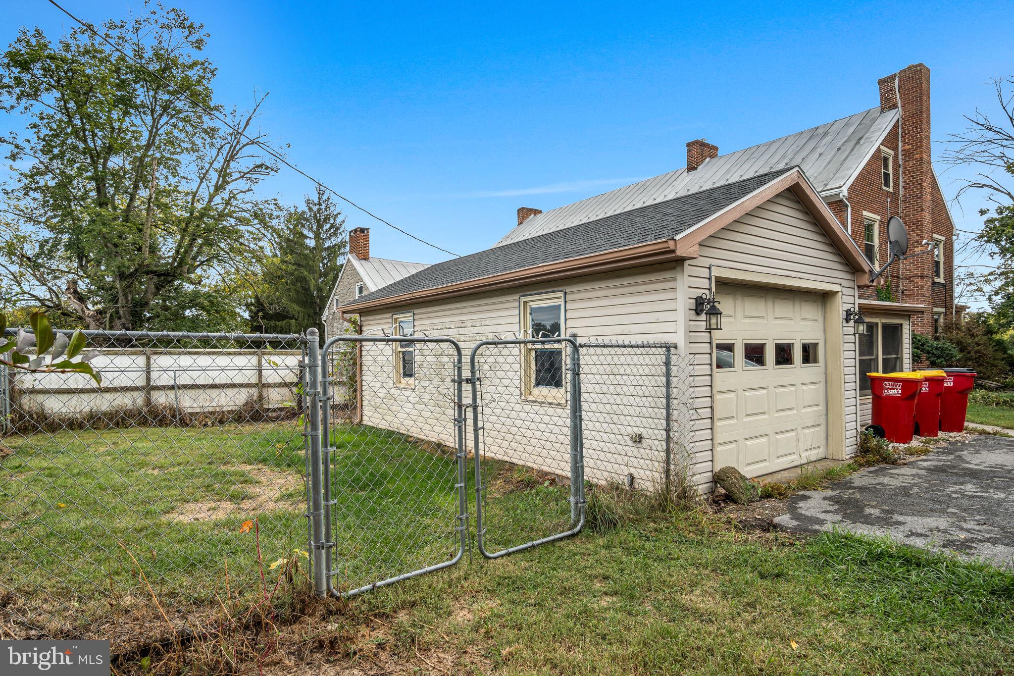 2143 Newville Road Carlisle, PA 17015 - Photo 29 of 40 a white house that has a small yard and a large tree