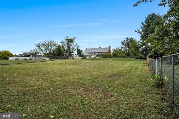 a view of a field with an trees in the background