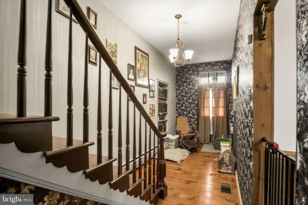 a view of entryway and hall with wooden floor
