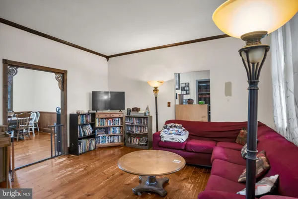 a living room with furniture a rug and a flat screen tv