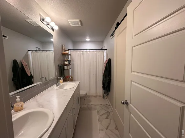 a bathroom with a double vanity sink and mirror