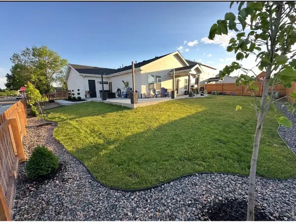 a view of a house with a backyard porch and sitting area
