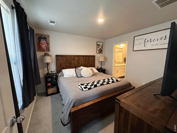 a bedroom with furniture and a window