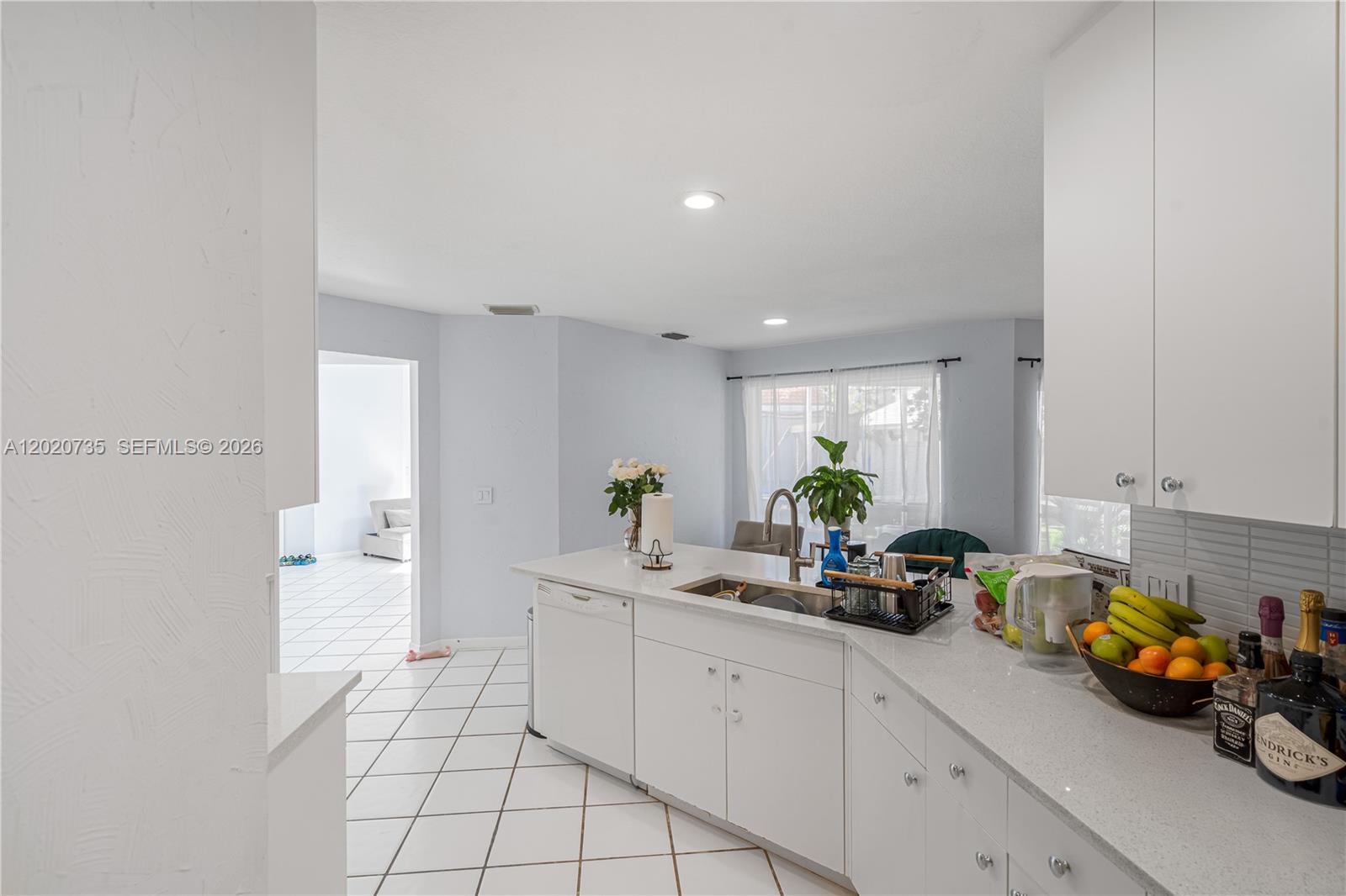 17244 Balboa Point Way Boca Raton, FL 33487 - Photo 42 of 66 a kitchen with stainless steel appliances a sink a window and white cabinets