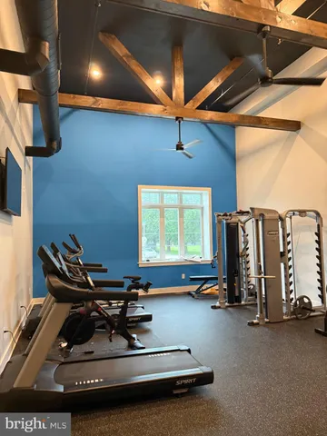 a room with gym equipment and a large window