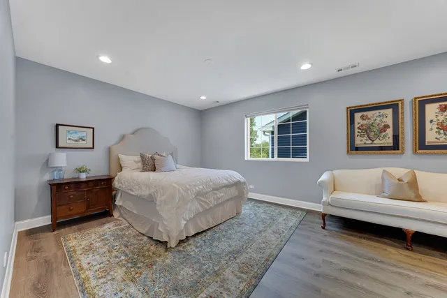 a bedroom with a large bed and a couch