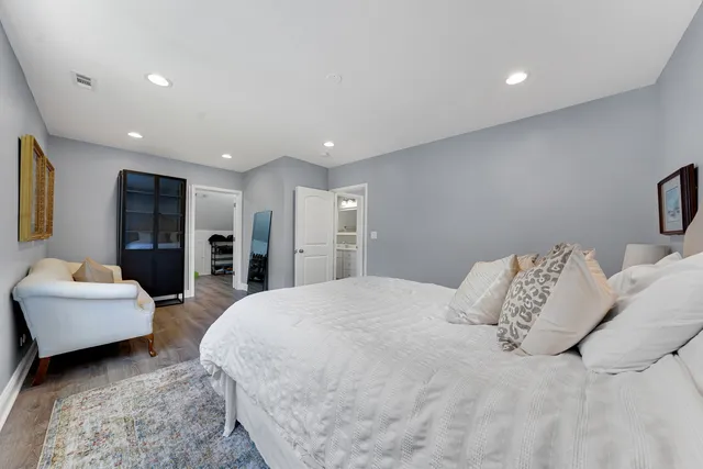 a large bedroom with a bed and a couch