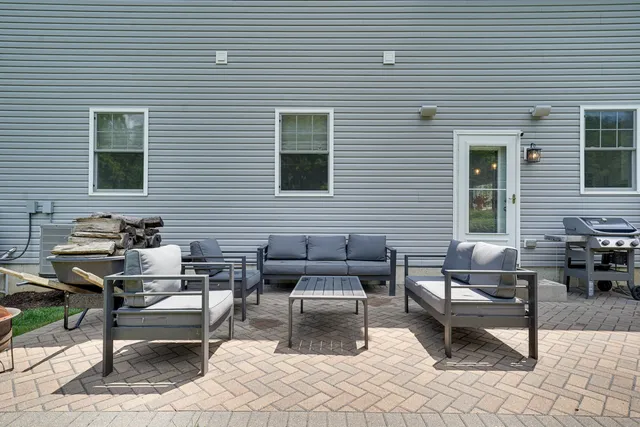 a backyard of a house with outdoor seating