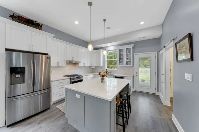 a kitchen with a refrigerator a sink dishwasher a stove and a refrigerator