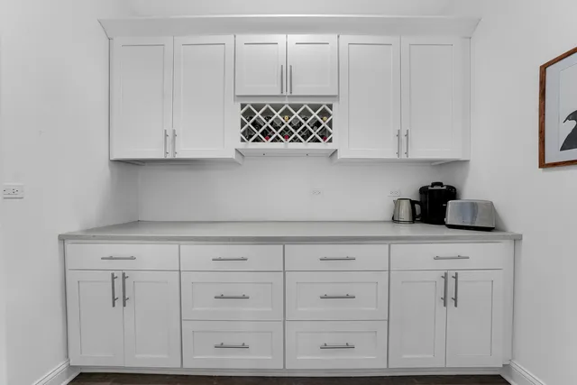 a kitchen with white cabinets and a stove