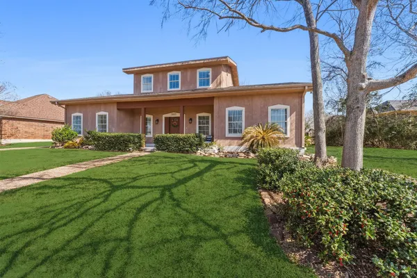 a front view of house with yard and green space