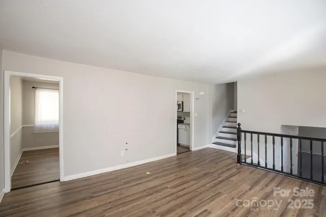 a kitchen with stainless steel appliances granite countertop a sink a stove top oven a counter space and cabinets