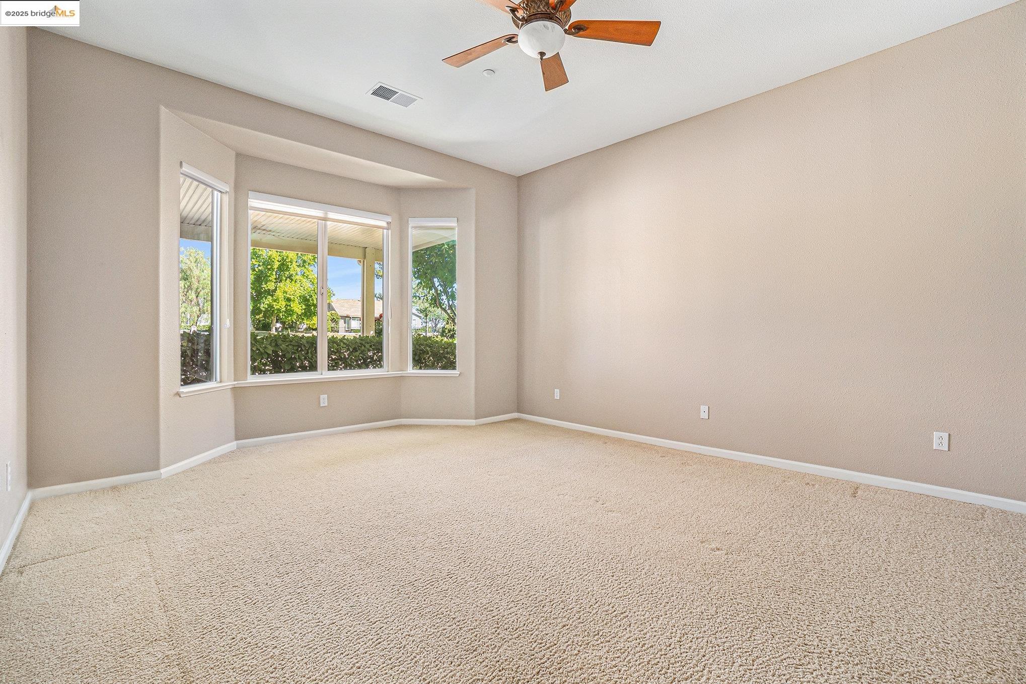 599 Pomona Drive Brentwood, CA 94513 - Photo 10 of 35 Empty room featuring carpet and a ceiling fan