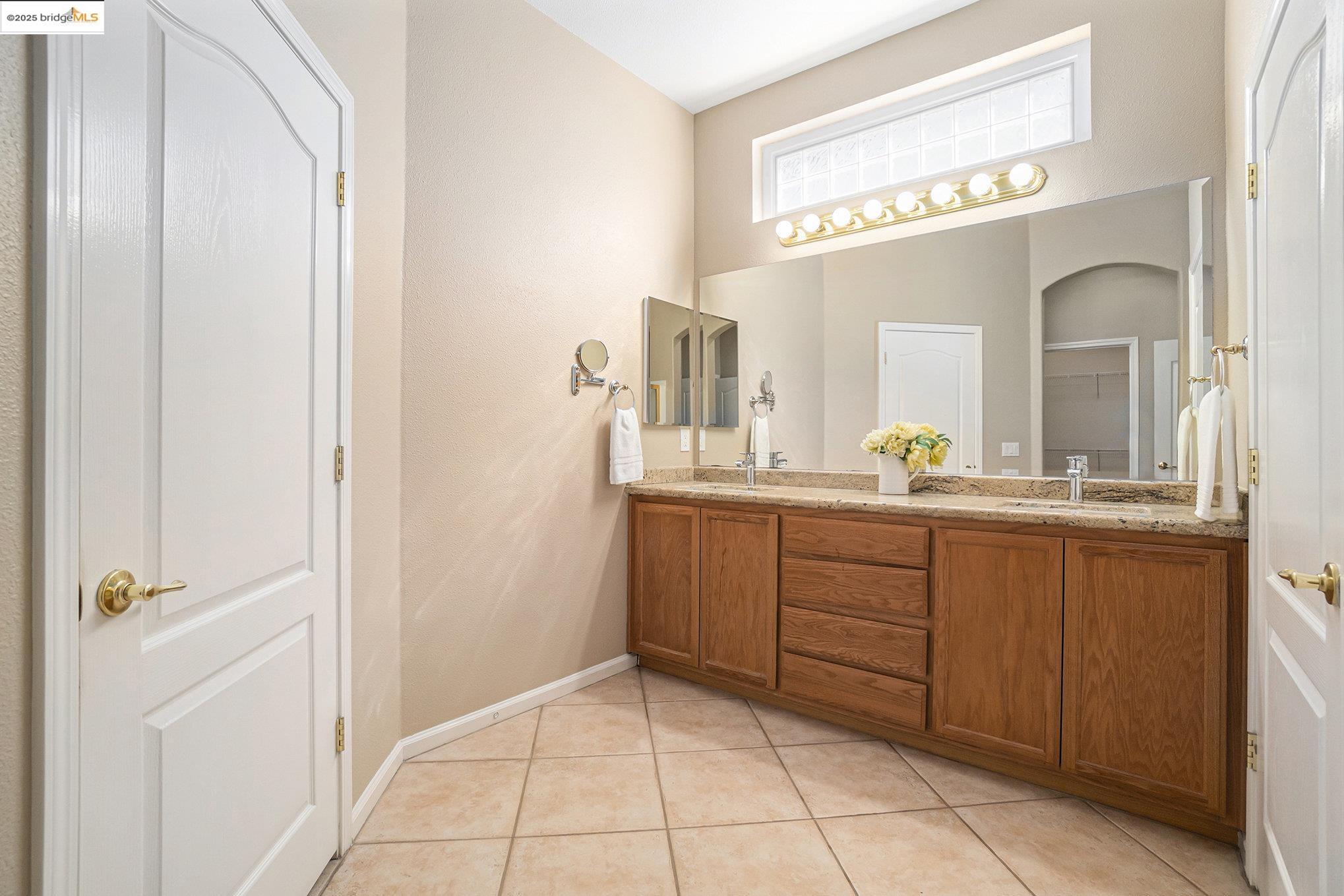 599 Pomona Drive Brentwood, CA 94513 - Photo 11 of 35 Full bath with double vanity and tile patterned flooring