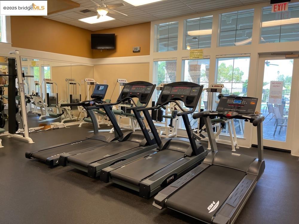 599 Pomona Drive Brentwood, CA 94513 - Photo 31 of 35 Workout area with a paneled ceiling, a towering ceiling, and ceiling fan