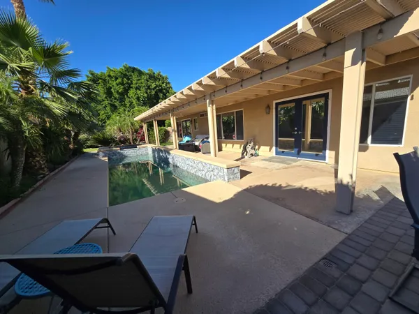 a view of a backyard with sitting area