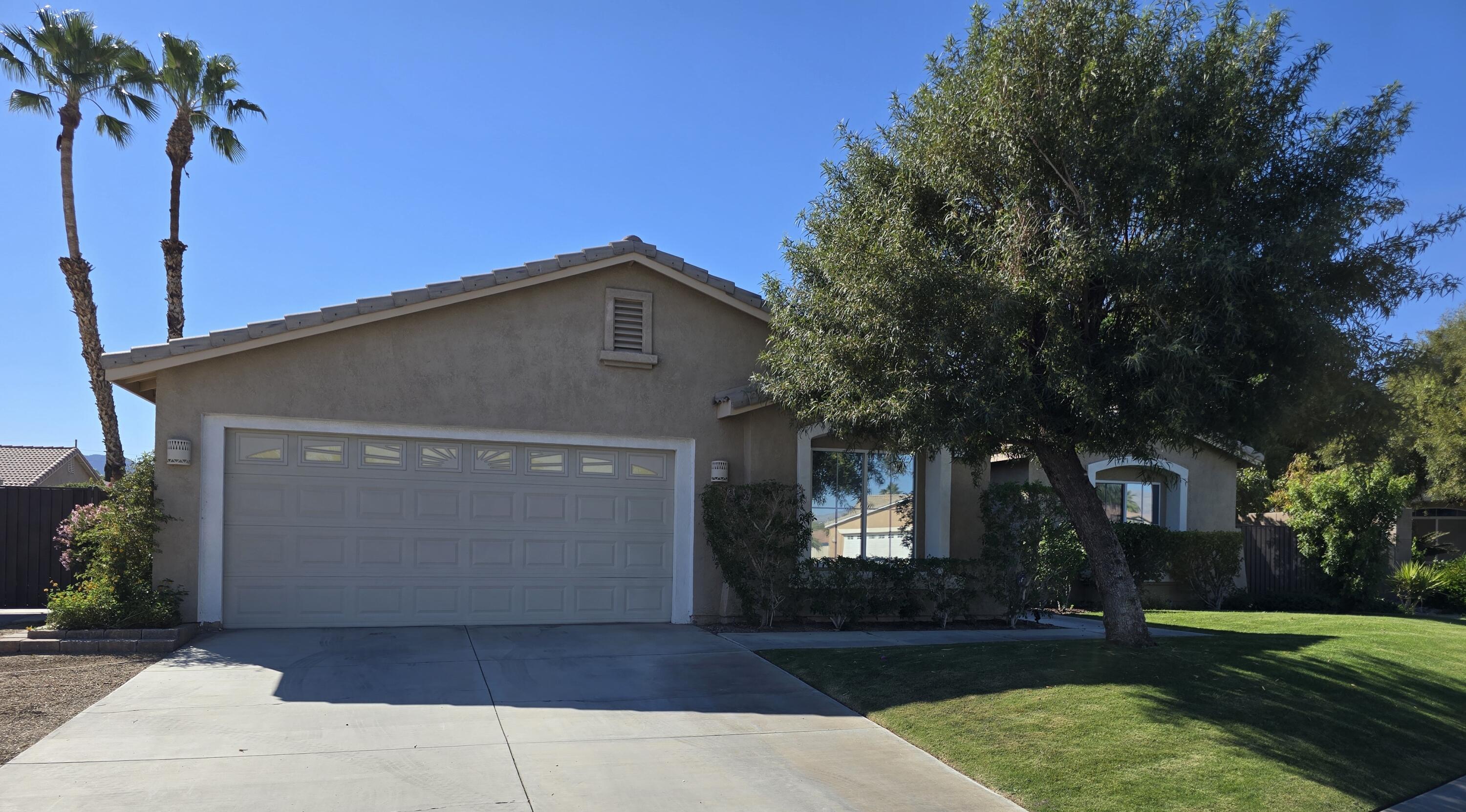 47719 Avocado Court Indio, CA 92201 - Photo 2 of 22 a front view of a house with a yard