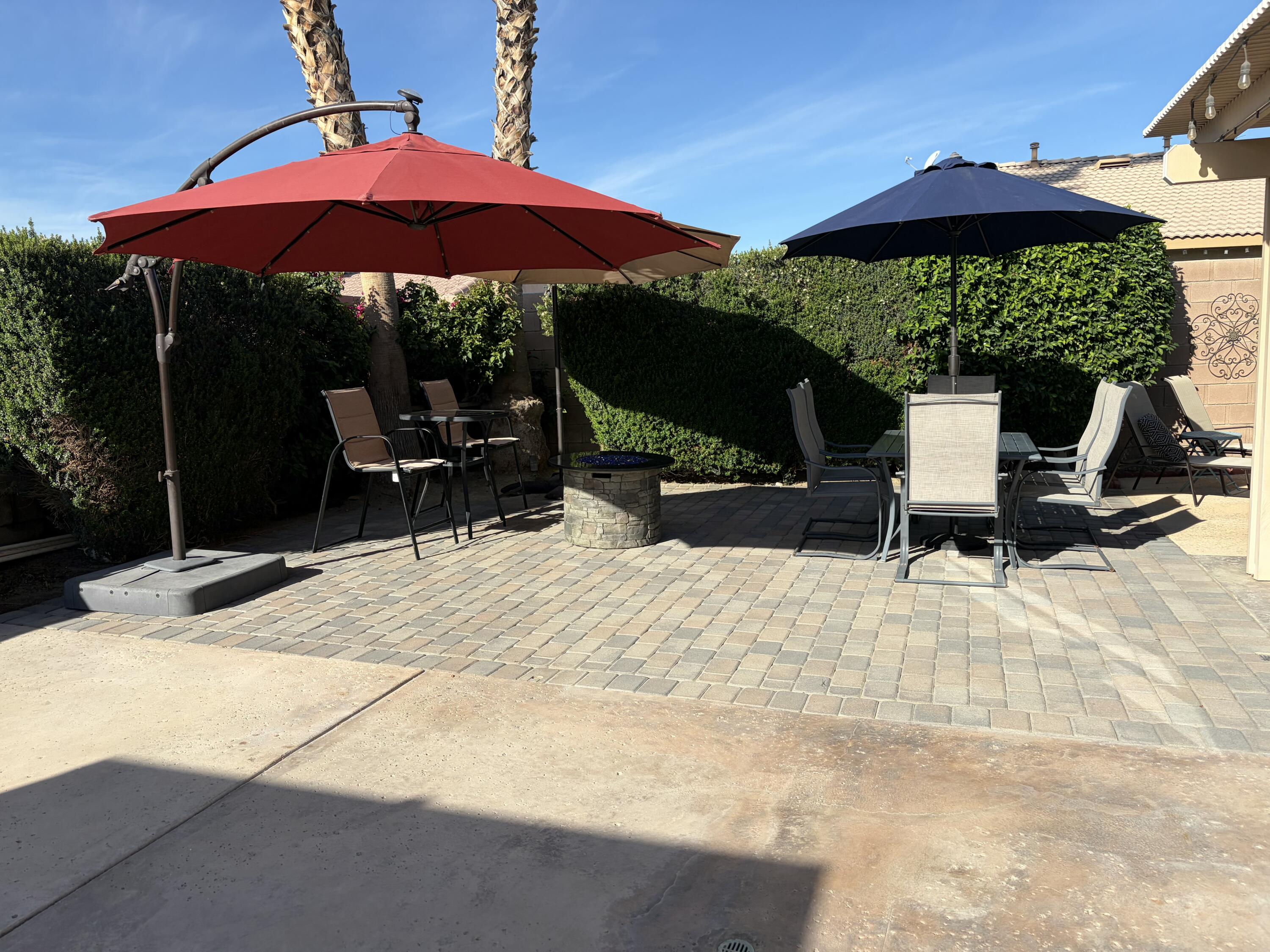 47719 Avocado Court Indio, CA 92201 - Photo 21 of 22 a view of a patio with a table and chairs under an umbrella