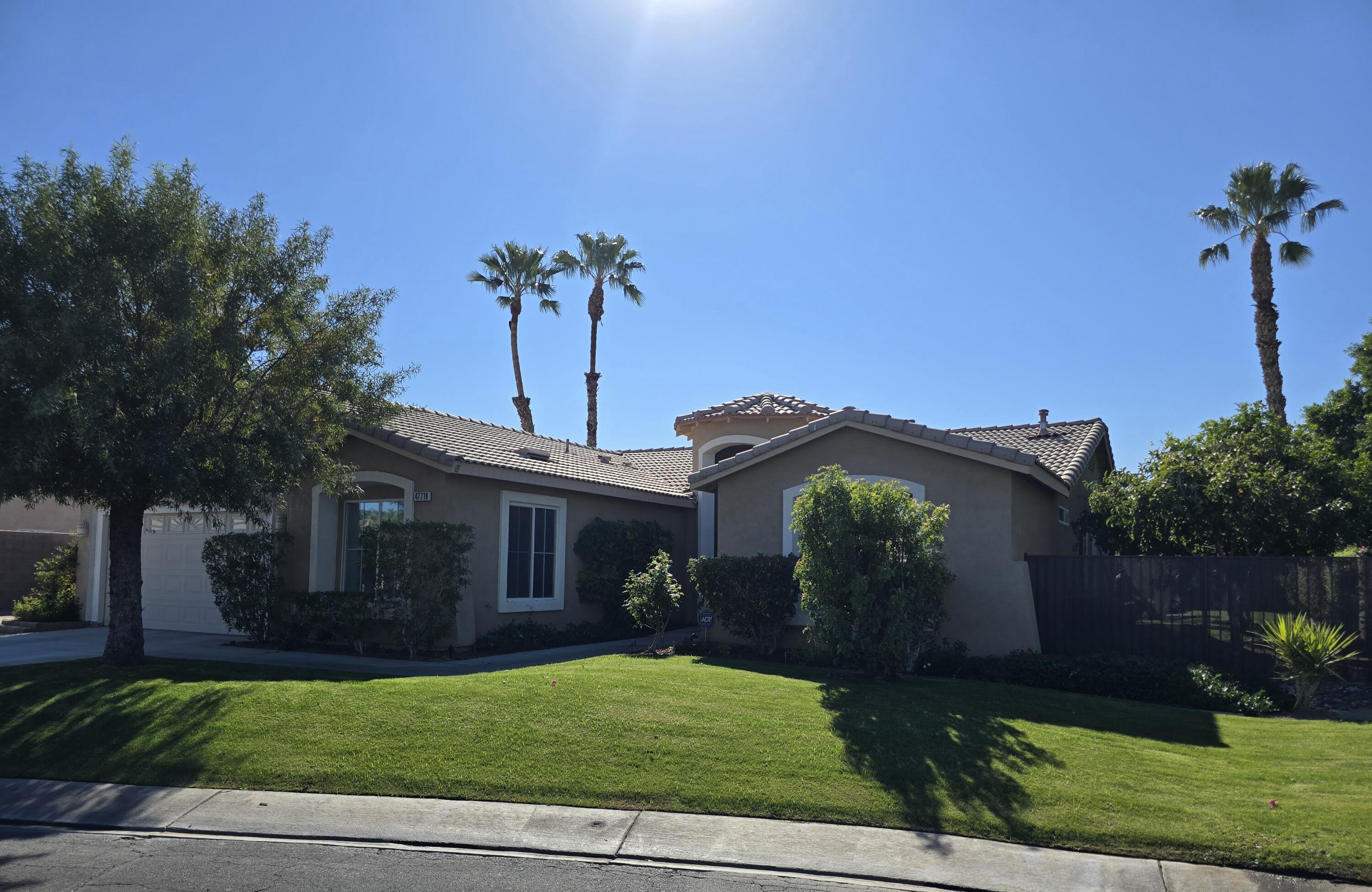 47719 Avocado Court Indio, CA 92201 - Photo 3 of 22 a front view of a house with a garden