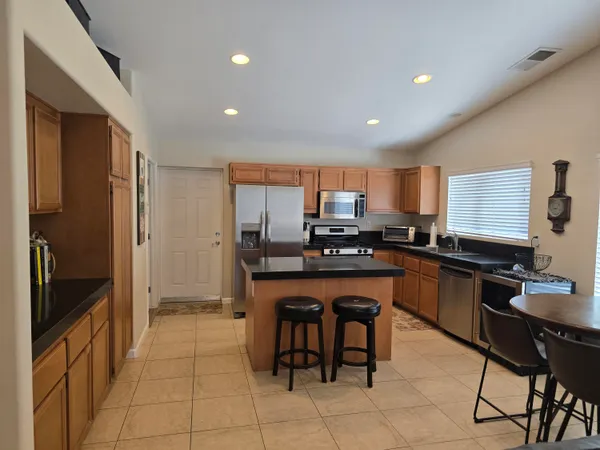 a kitchen with stainless steel appliances a refrigerator and a stove top oven