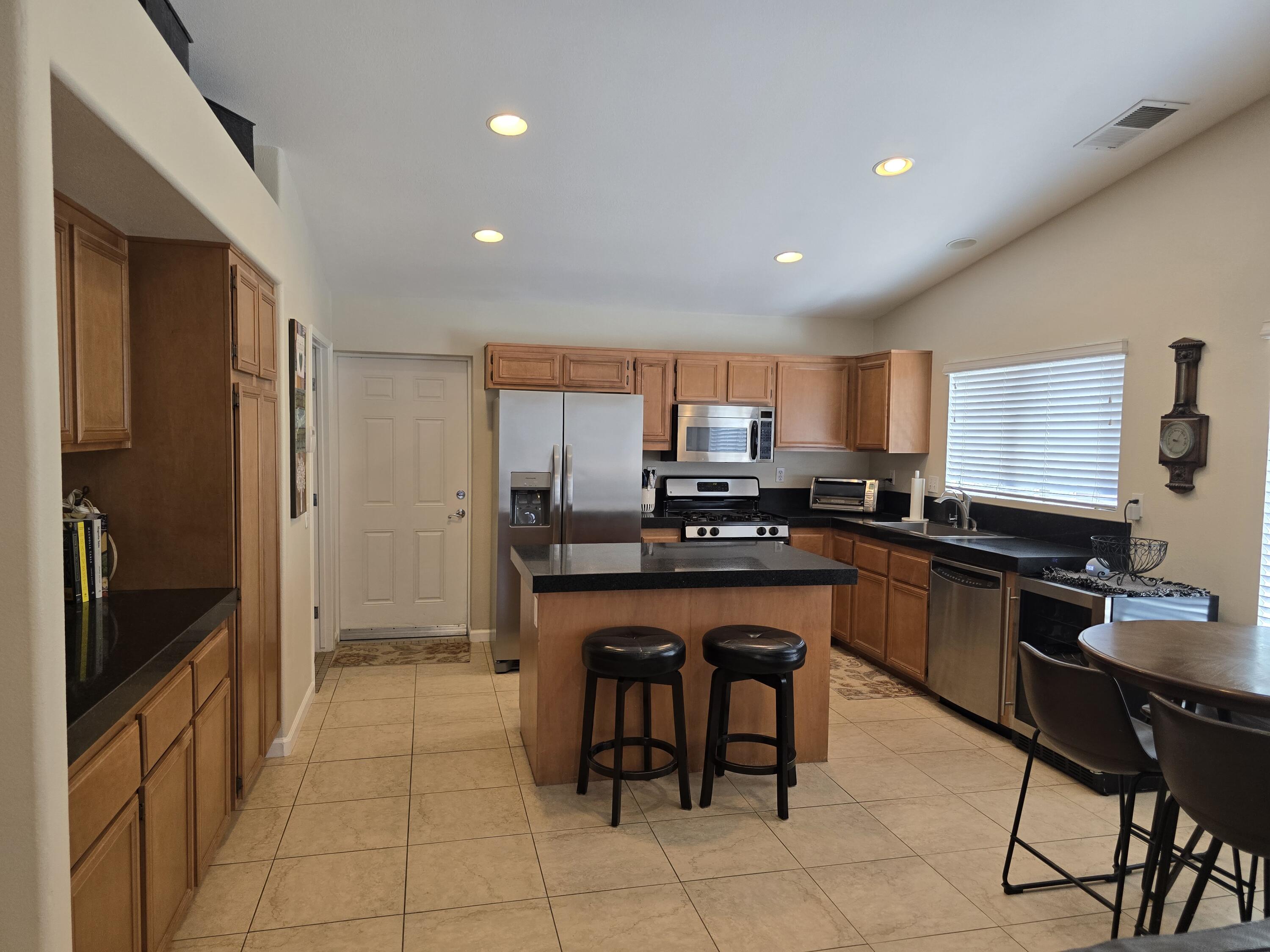 47719 Avocado Court Indio, CA 92201 - Photo 4 of 22 a kitchen with stainless steel appliances a refrigerator and a stove top oven