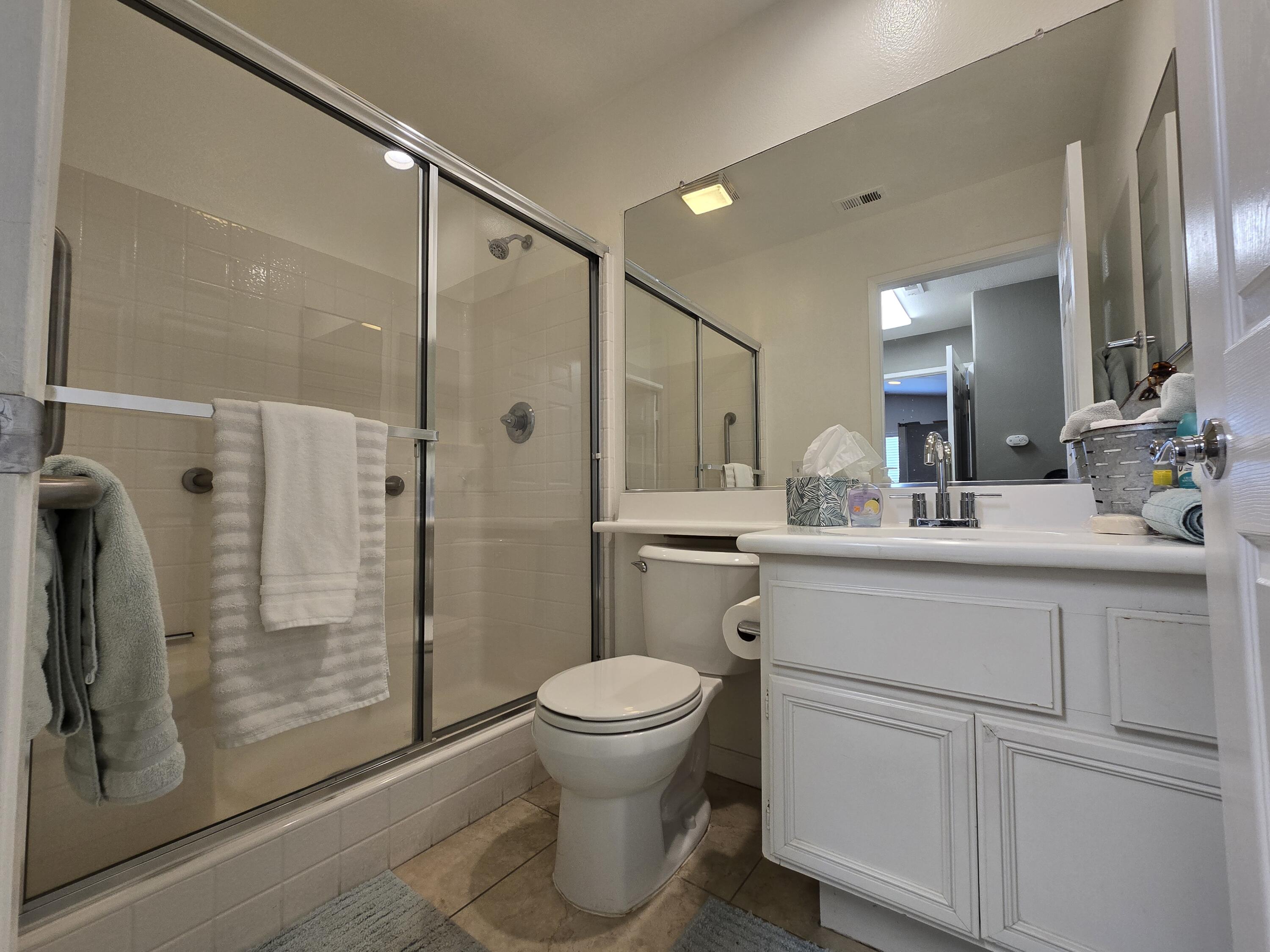 47719 Avocado Court Indio, CA 92201 - Photo 9 of 22 a bathroom with a shower a sink a toilet and a mirror