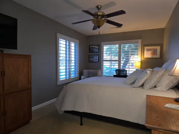 a bed sitting in a bedroom next to a window