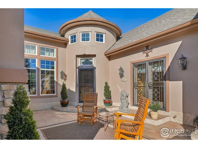 a front view of a house with outdoor seating