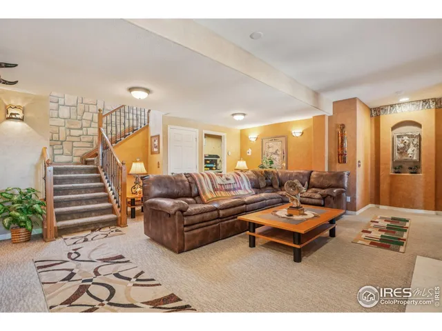 a living room with furniture hard wood floor and white walls