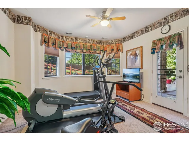 a living room with furniture a piano and a window