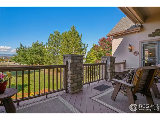 a view of a chairs and table in patio with wooden fence