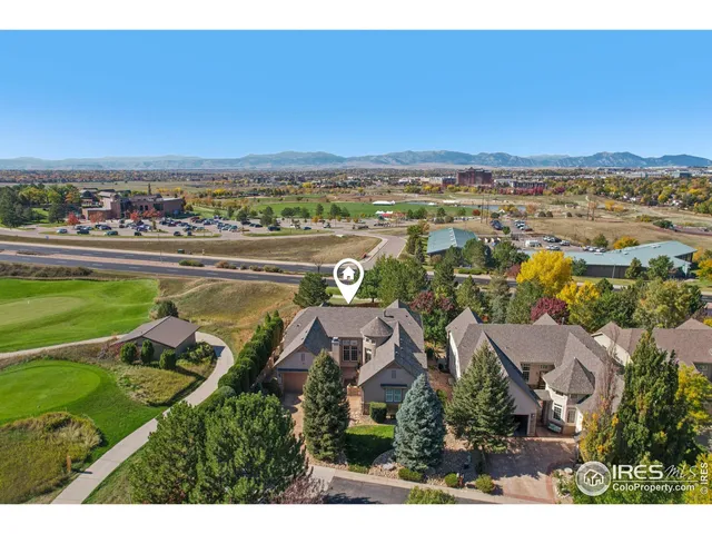 an aerial view of residential houses with outdoor space and ocean view