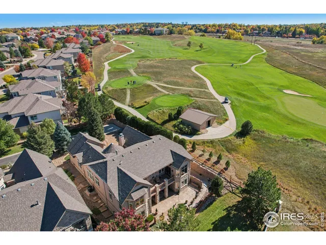 an aerial view of a house with a big yard