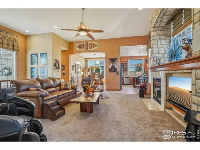a living room with furniture a dining table and a fireplace