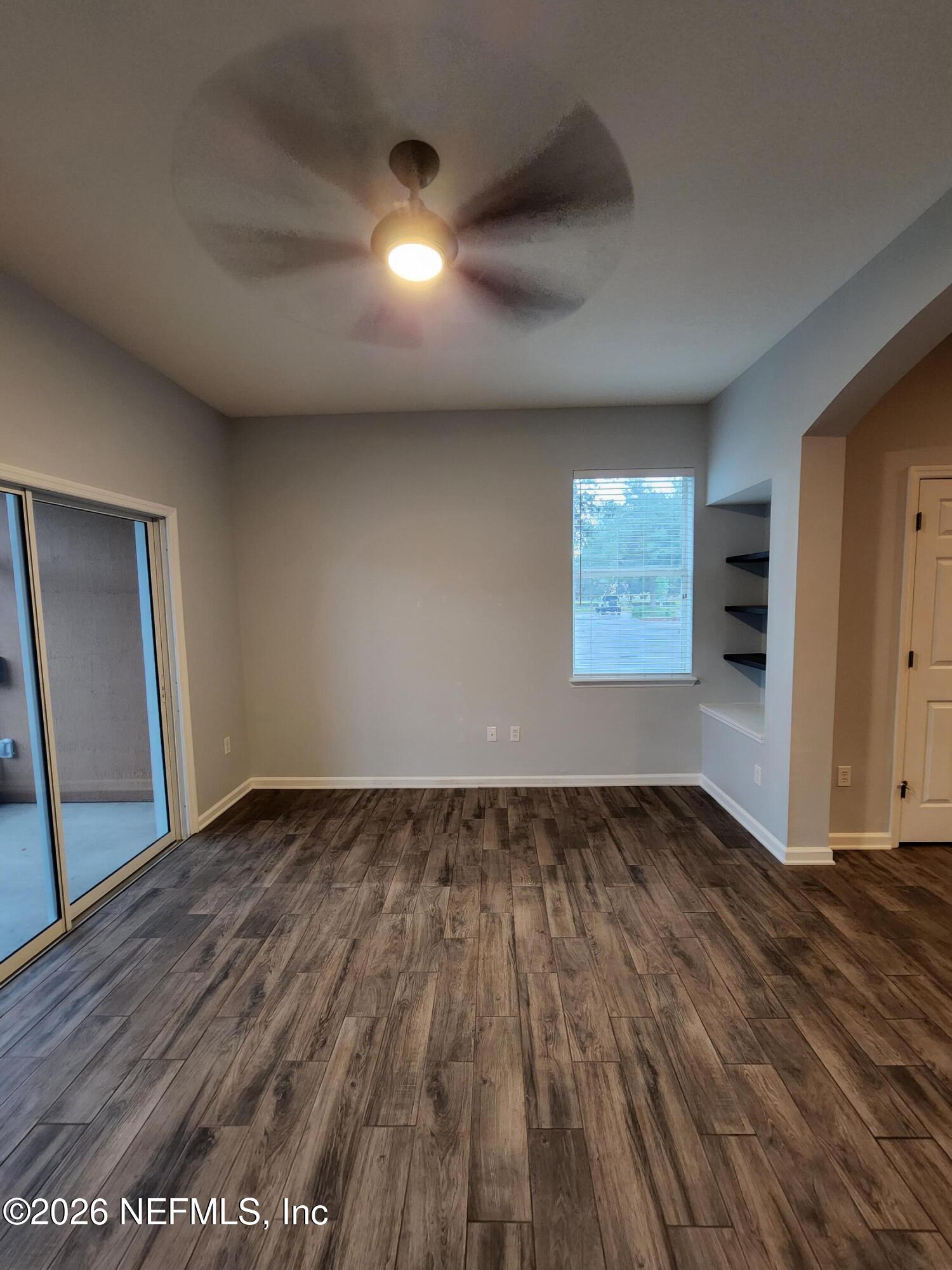 13030 Shallowater Road Jacksonville, FL 32258 - Photo 13 of 27 an empty room with wooden floor and windows