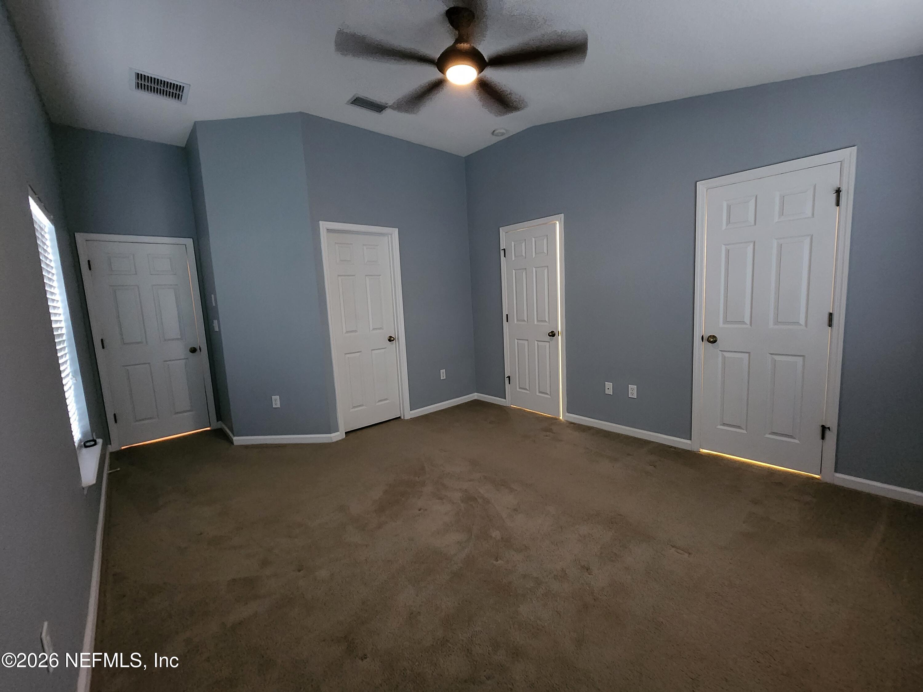 13030 Shallowater Road Jacksonville, FL 32258 - Photo 16 of 27 an empty room with windows and fan