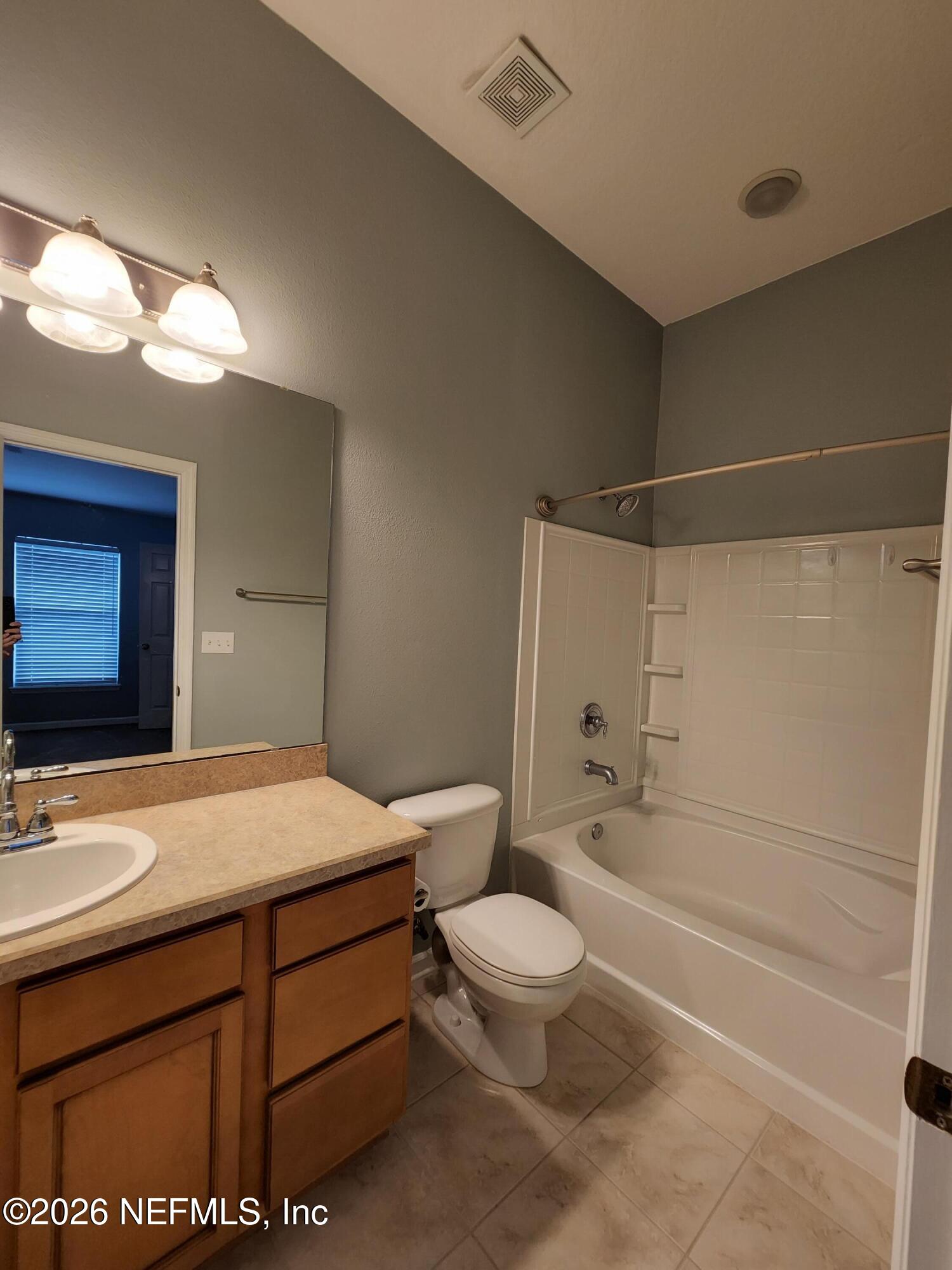 13030 Shallowater Road Jacksonville, FL 32258 - Photo 17 of 27 a bathroom with a sink a toilet and bathtub