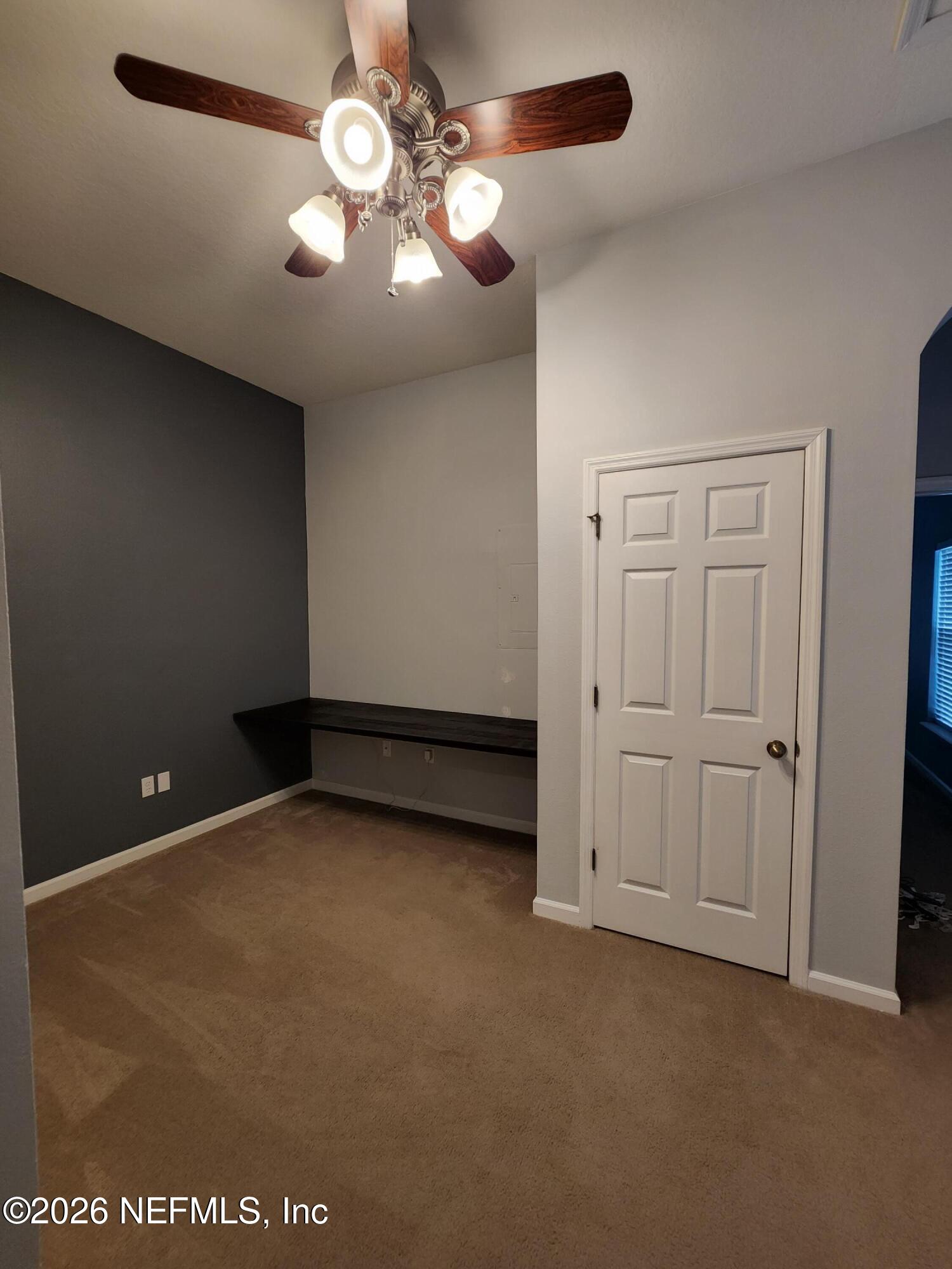 13030 Shallowater Road Jacksonville, FL 32258 - Photo 19 of 27 en empty room with windows and fan
