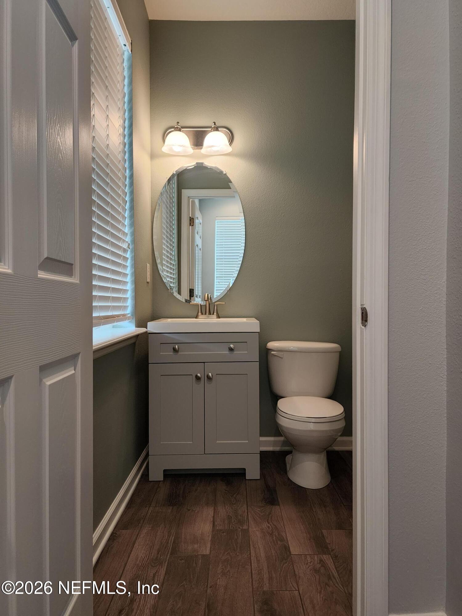 13030 Shallowater Road Jacksonville, FL 32258 - Photo 6 of 27 a bathroom with a toilet a sink and mirror