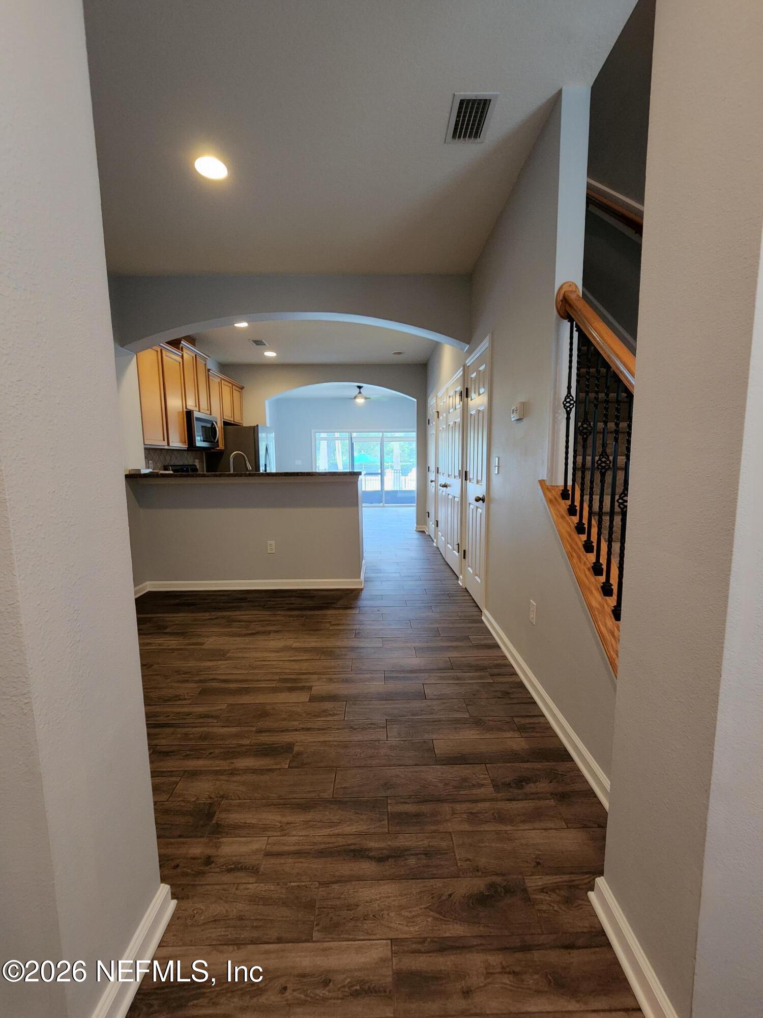 13030 Shallowater Road Jacksonville, FL 32258 - Photo 8 of 27 a view of a hallway with wooden floor and staircase