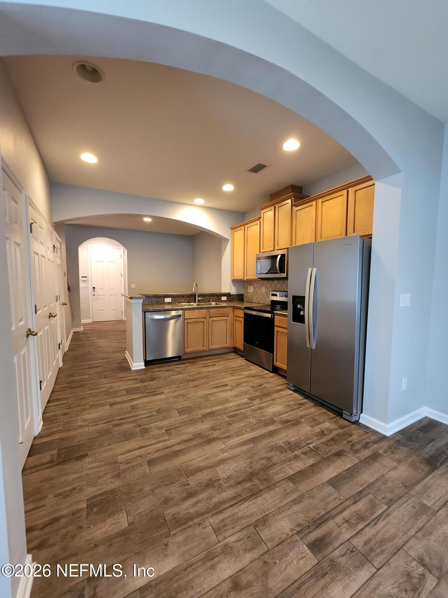 13030 Shallowater Road Jacksonville, FL 32258 - Photo 10 of 27 a large kitchen with a refrigerator a stove top oven a sink and dishwasher