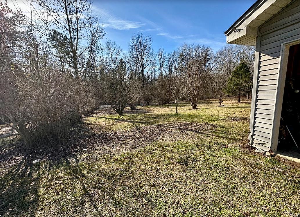 8825 Wolf Pen Road Pocahontas, TN 38061 - Photo 9 of 14 a backyard of a house with a yard and outdoor seating