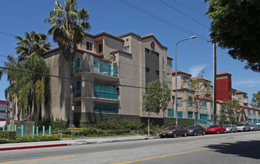 a city street lined with buildings and trees