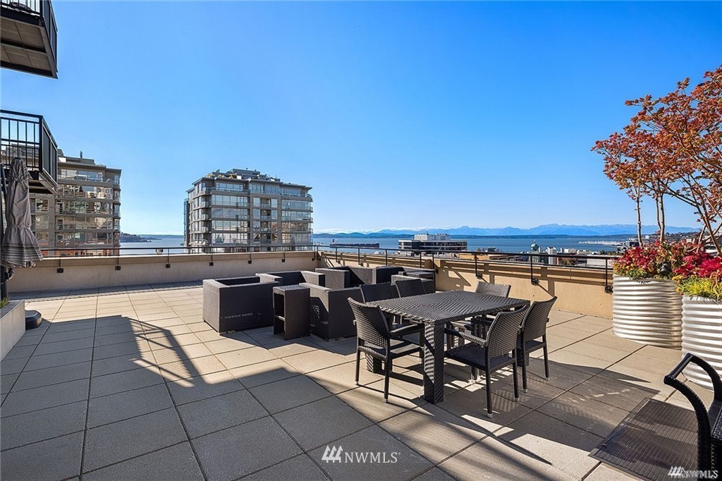 2911 2nd Avenue, Unit 818 Seattle, WA 98121 - Photo 11 of 16 a view of a terrace with furniture and a fire pit