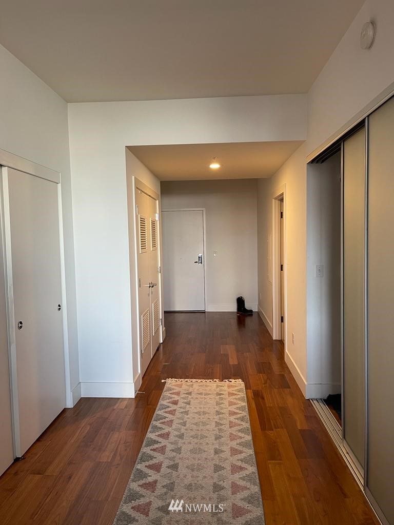 2911 2nd Avenue, Unit 818 Seattle, WA 98121 - Photo 16 of 16 a view of a bedroom with wooden floor and bathroom