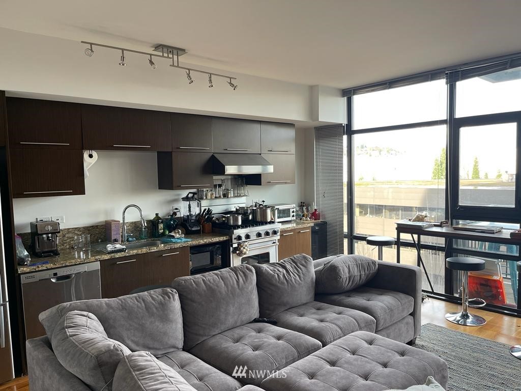 2911 2nd Avenue, Unit 818 Seattle, WA 98121 - Photo 4 of 16 a view of a living room kitchen and a large window
